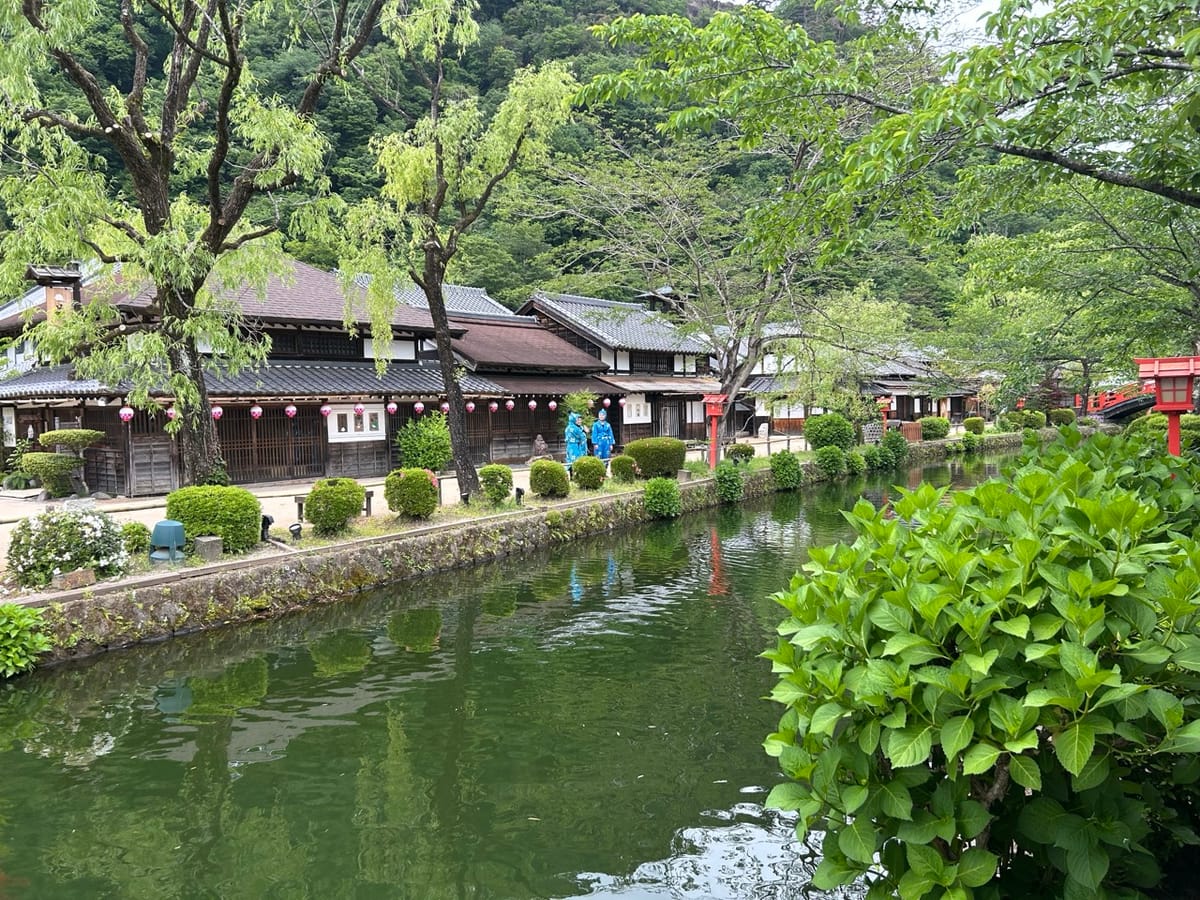 River with traditional Japanes houses along the opposite shore. 